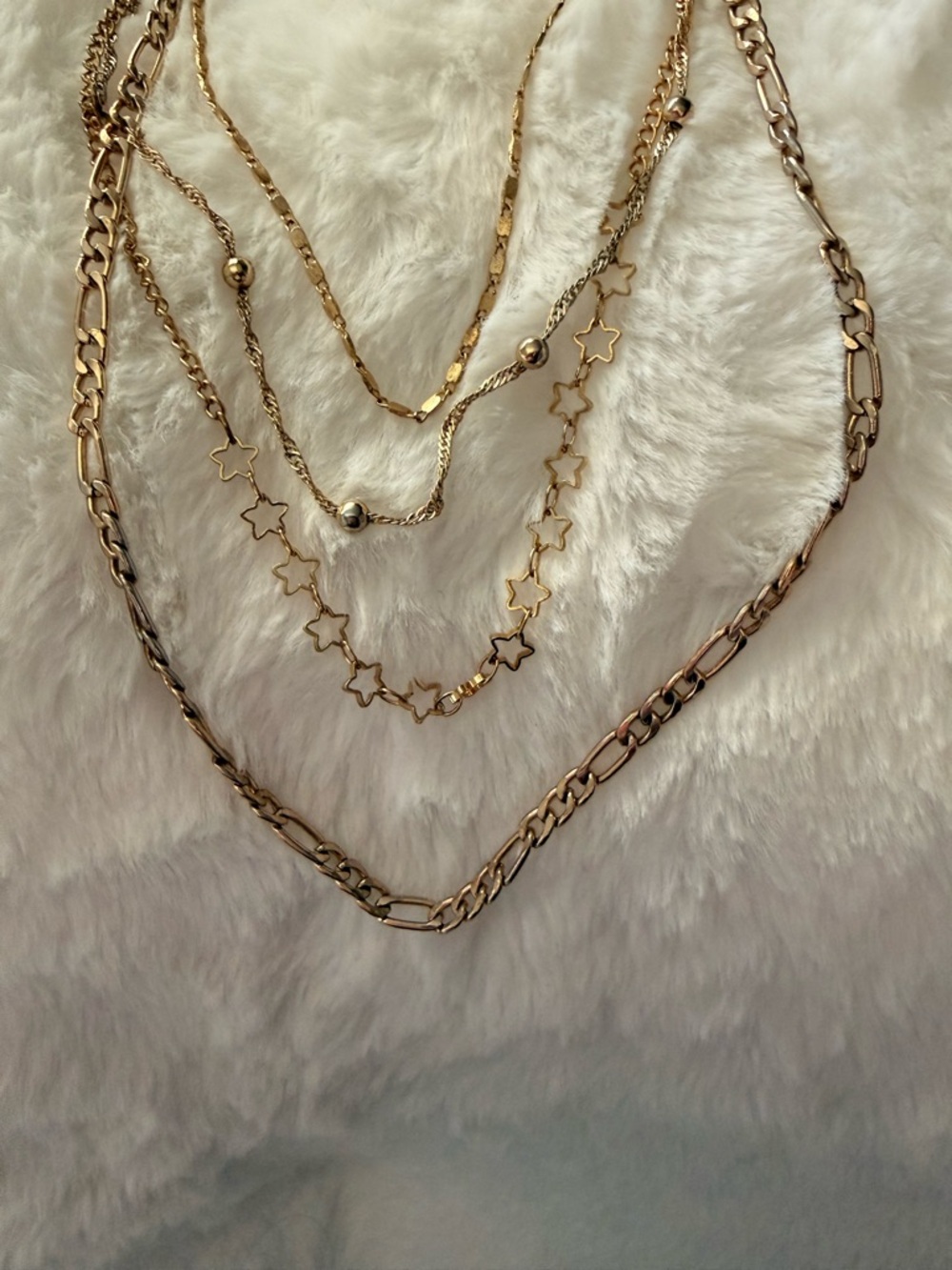four gold necklaces